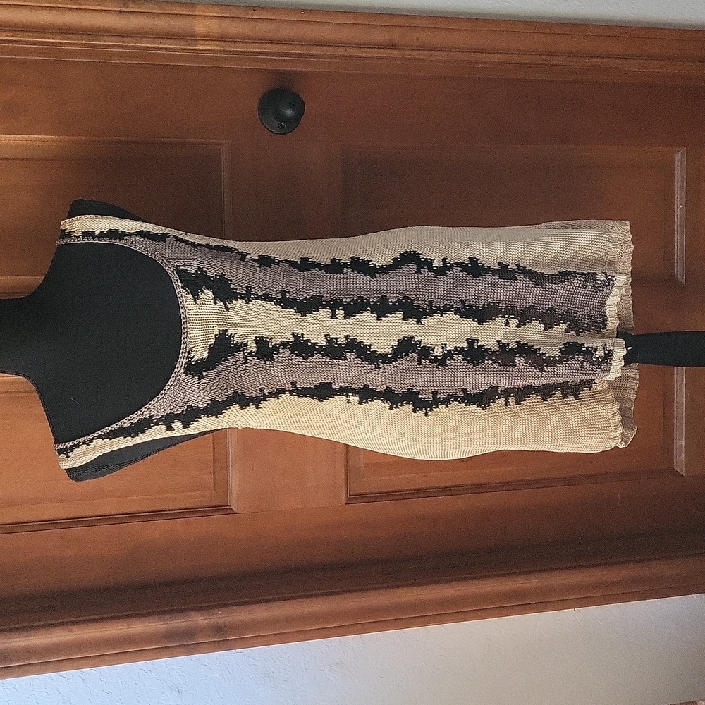Knit dress with tan, black and brown design on front.